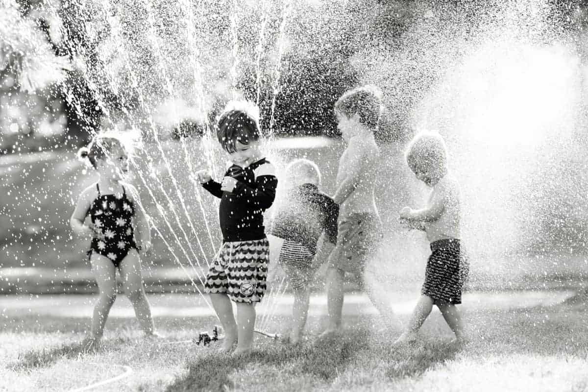 Taking summer sprinkler photos of kids