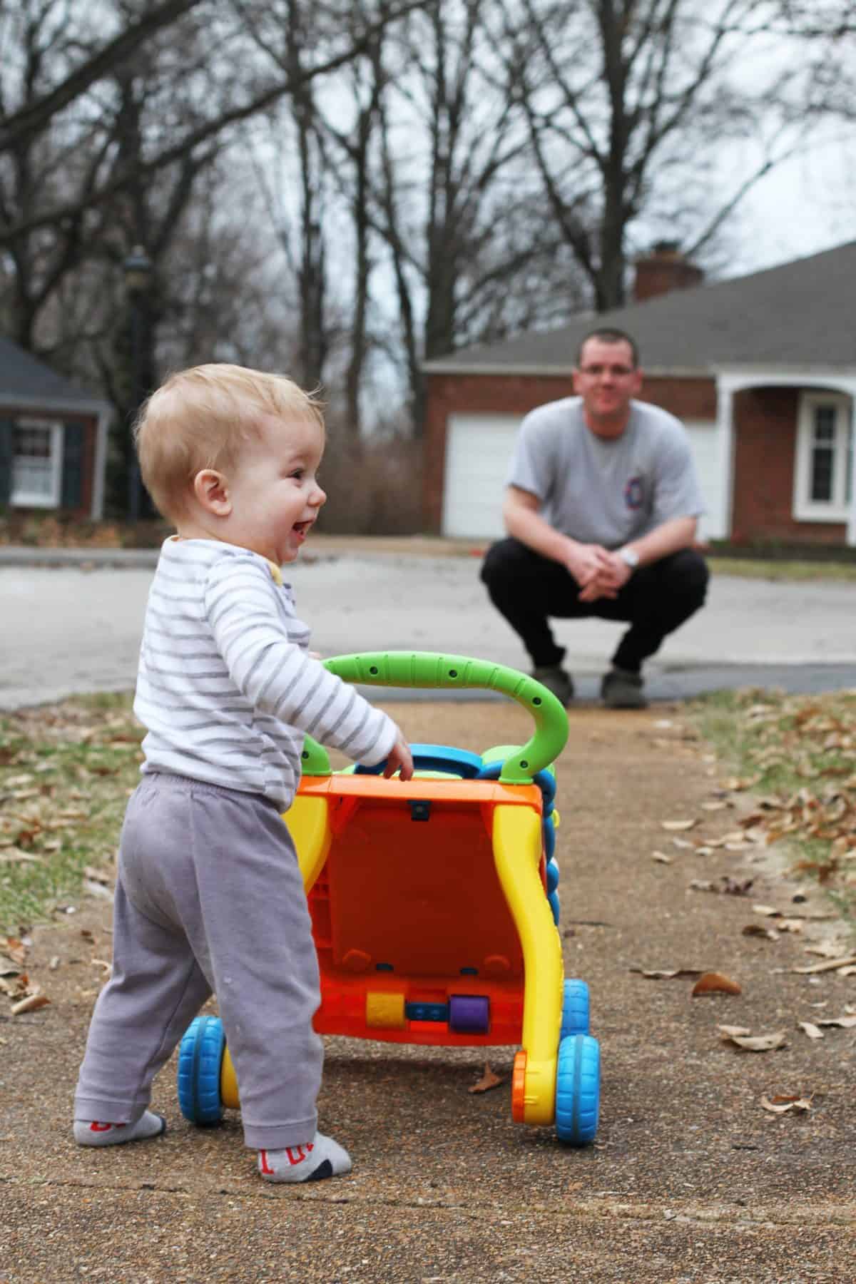 baby using a walker outside - learning to walk outdoors