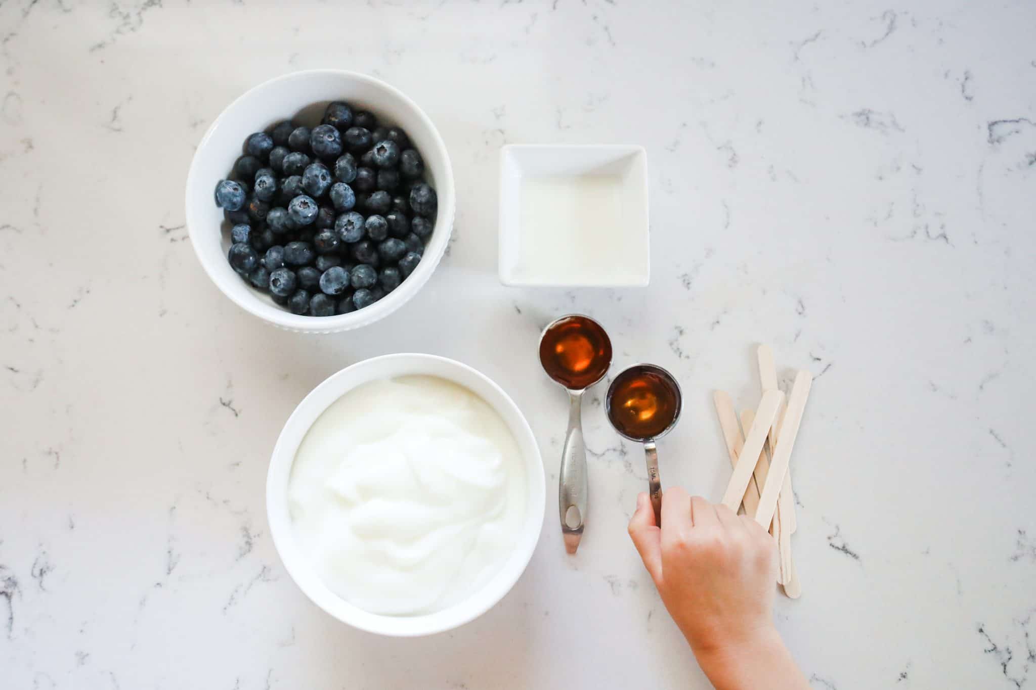 making blueberry yogurt popsicles with kids
