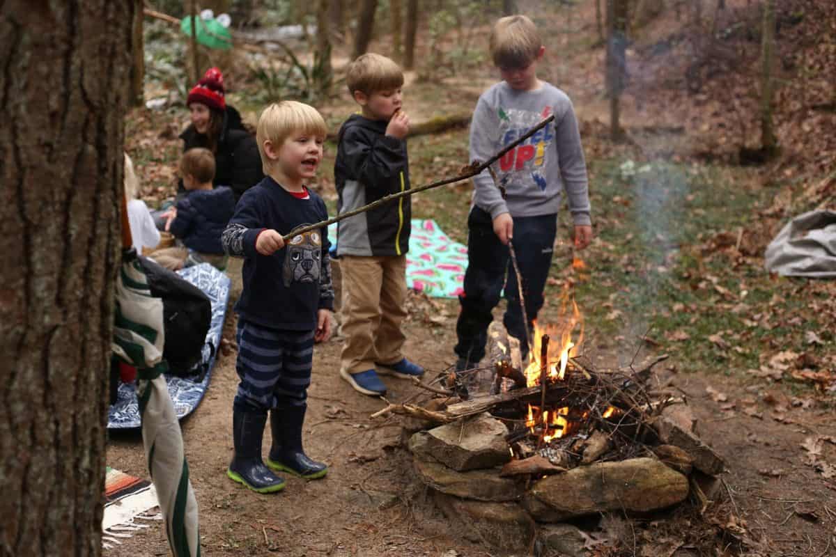 Starting an outdoor playgroup for kids - Making fires at base camp can be a skill-building opportunity as well as a chance to make memories.