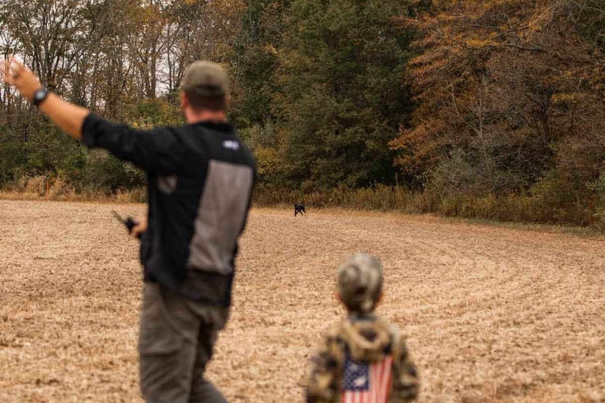 TW giving hand signals to direct hunting dog