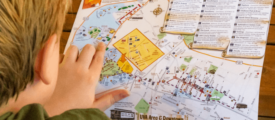 Kid pointing at a map