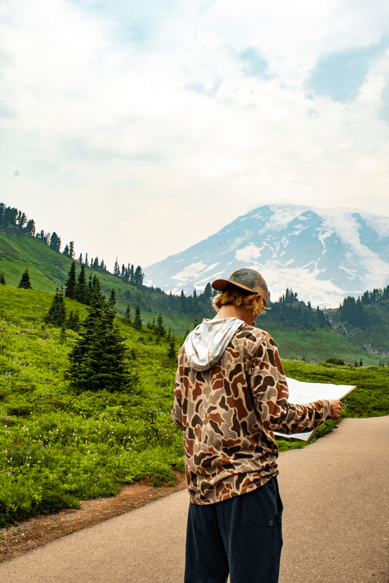 teenager reading a map in Mt. Rainier National Park