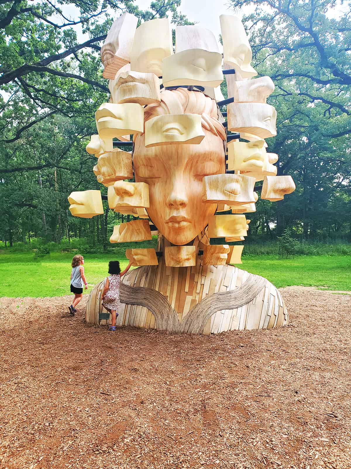 Morton Arboretum Sculpture with 2 girls playing - how to find nature in cities and urban areas