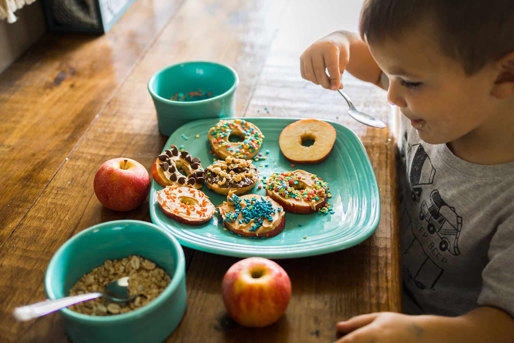 Child decorating apple slices