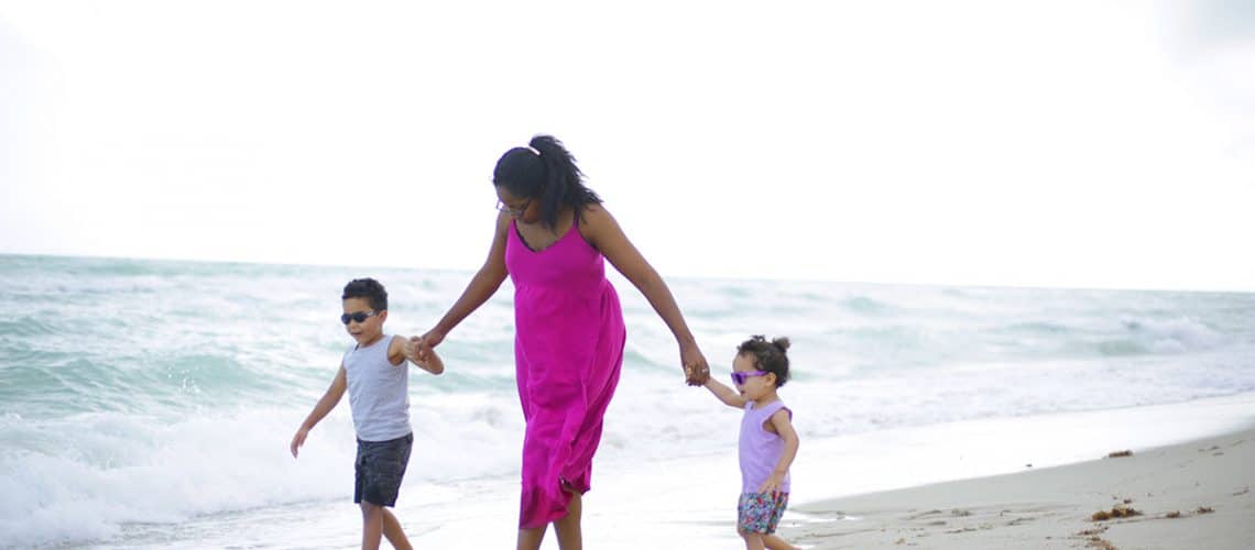 Mom and kids walking on the beach