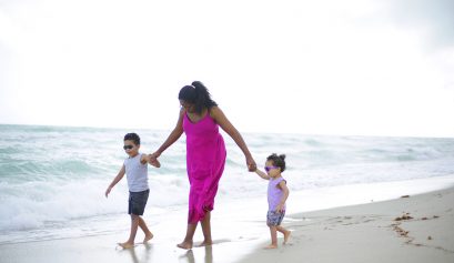 Mom and kids walking on the beach