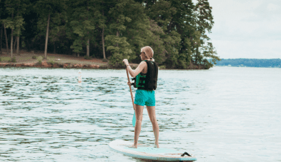 Teen girl on a paddleboard in a lake