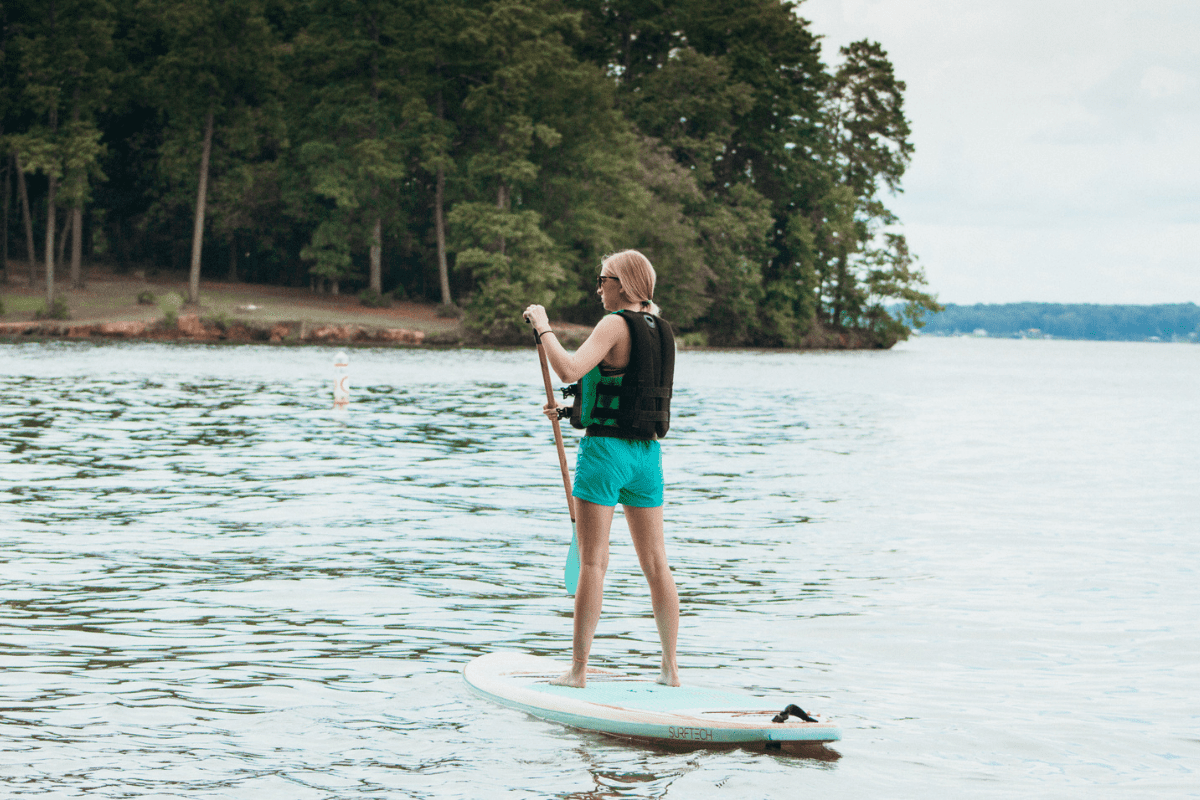 Teen girl on a paddleboard in a lake