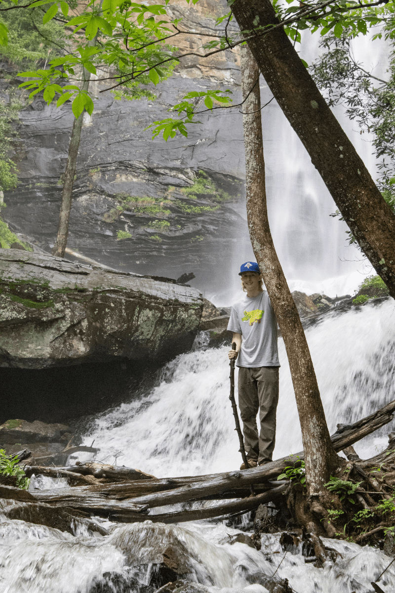 Teen Boy Crossing Waterfall