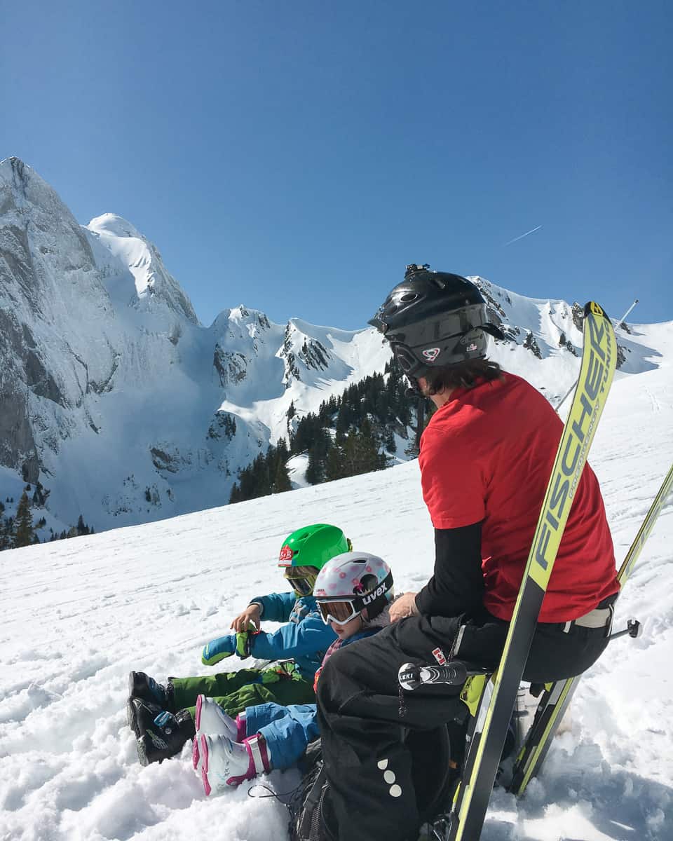 a family stop on the slope while downhill skiing together