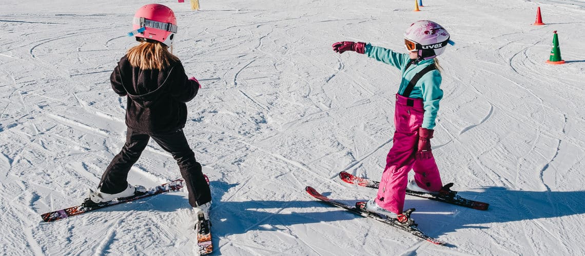 two kids learning skiing