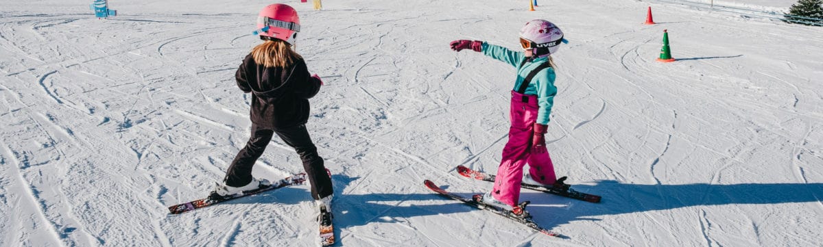 two kids learning skiing