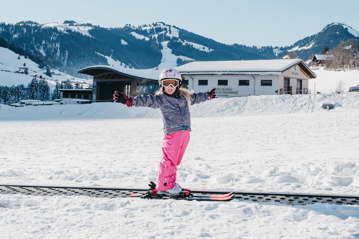 a child on a kids ski lift while learning to downhill ski