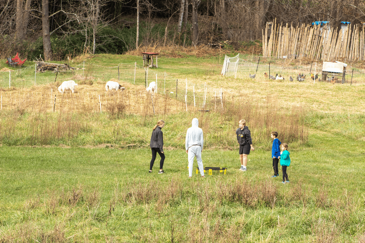 a group of kids playing games in a farm field