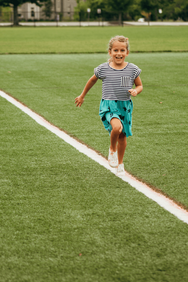 little girl running free on an open field