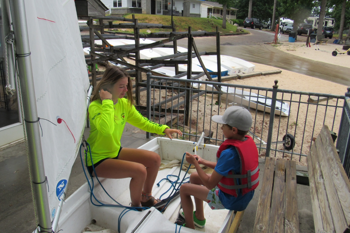 Sailing Instruction doing a lesson with a young sailor on land