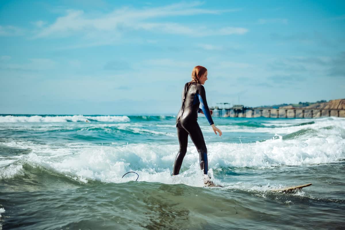 teenager surfing in white water - best surfboards for teens