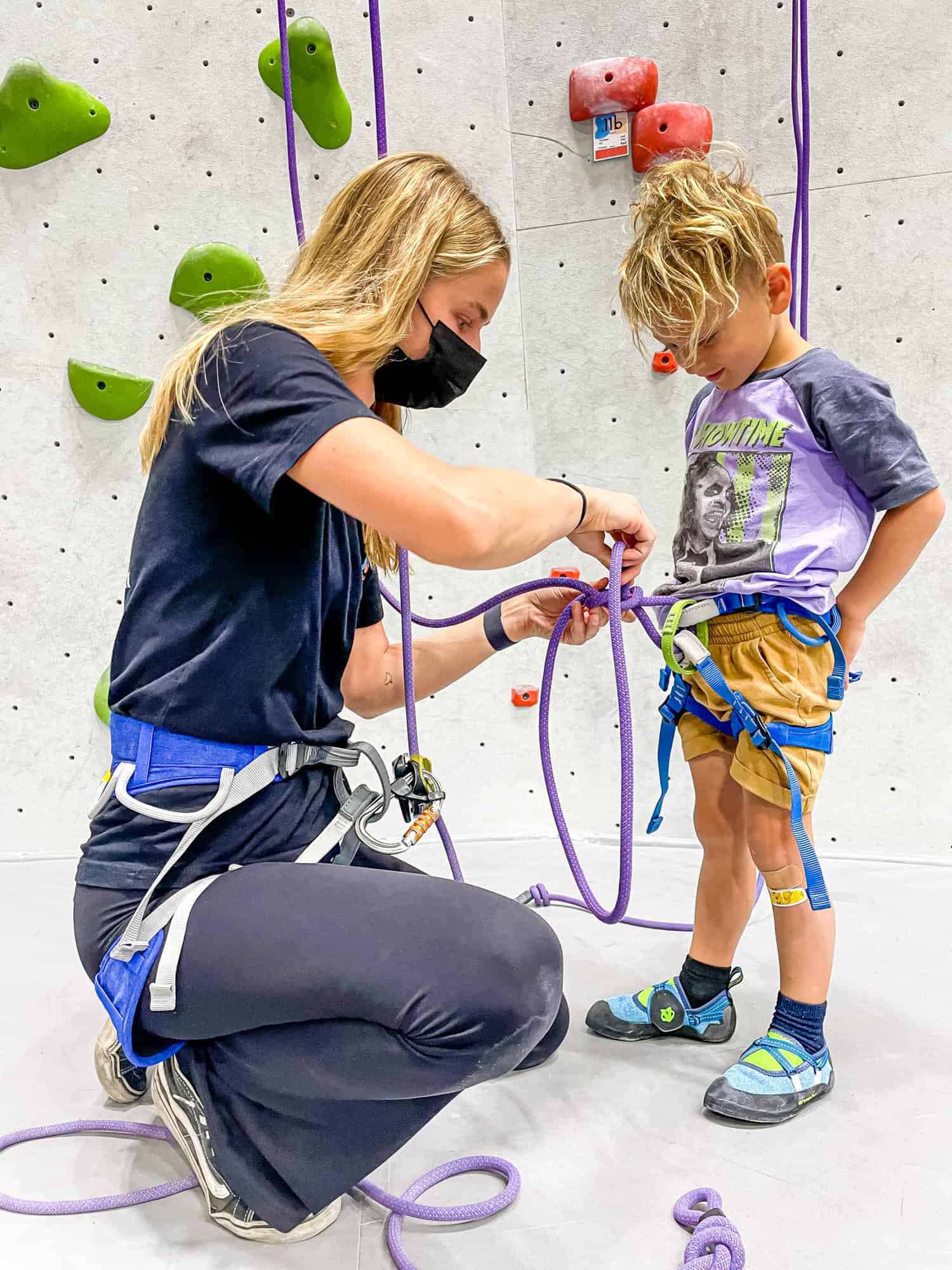 indoor rock climbing studio instructor tying knots