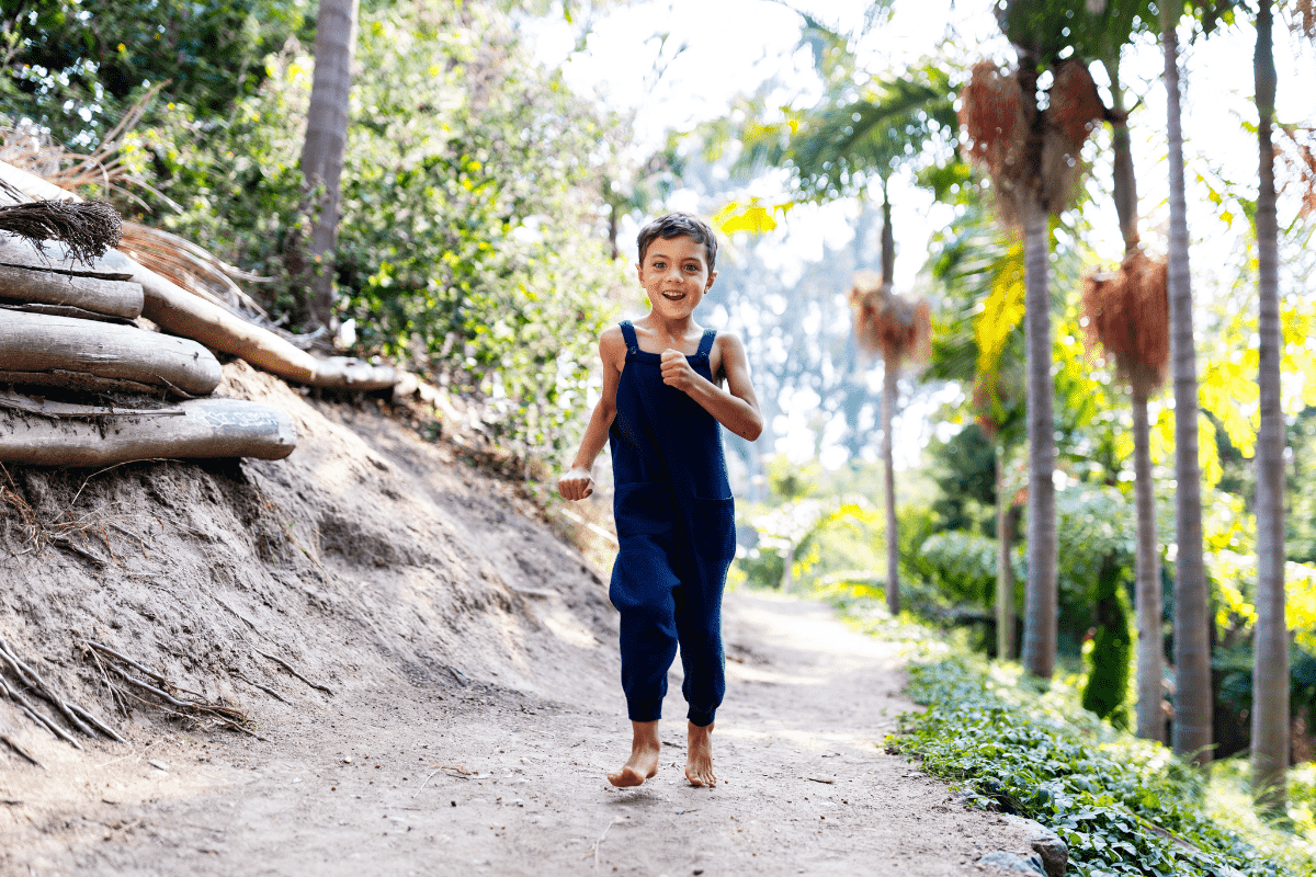 boy running barefoot on a trail in the san diego area 