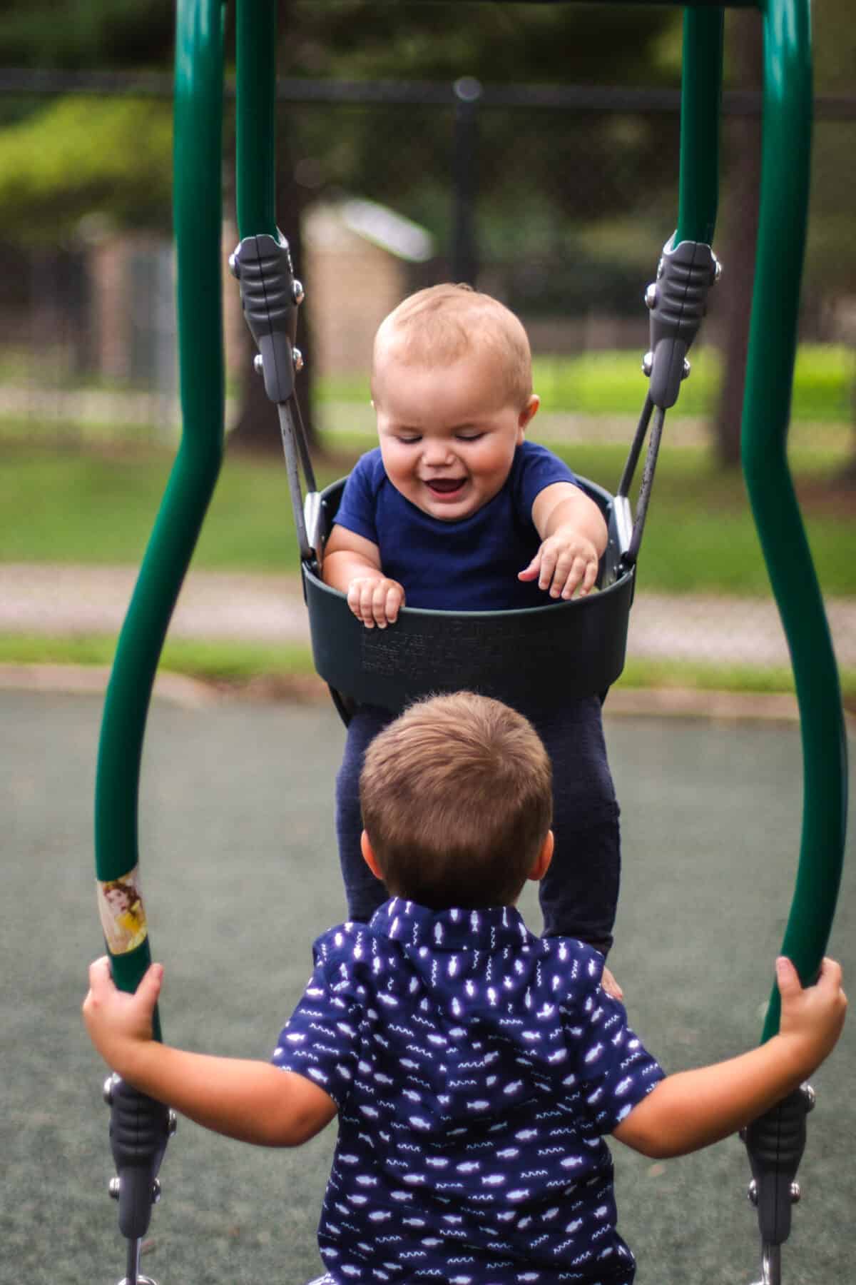 Two children on expression swing smiling