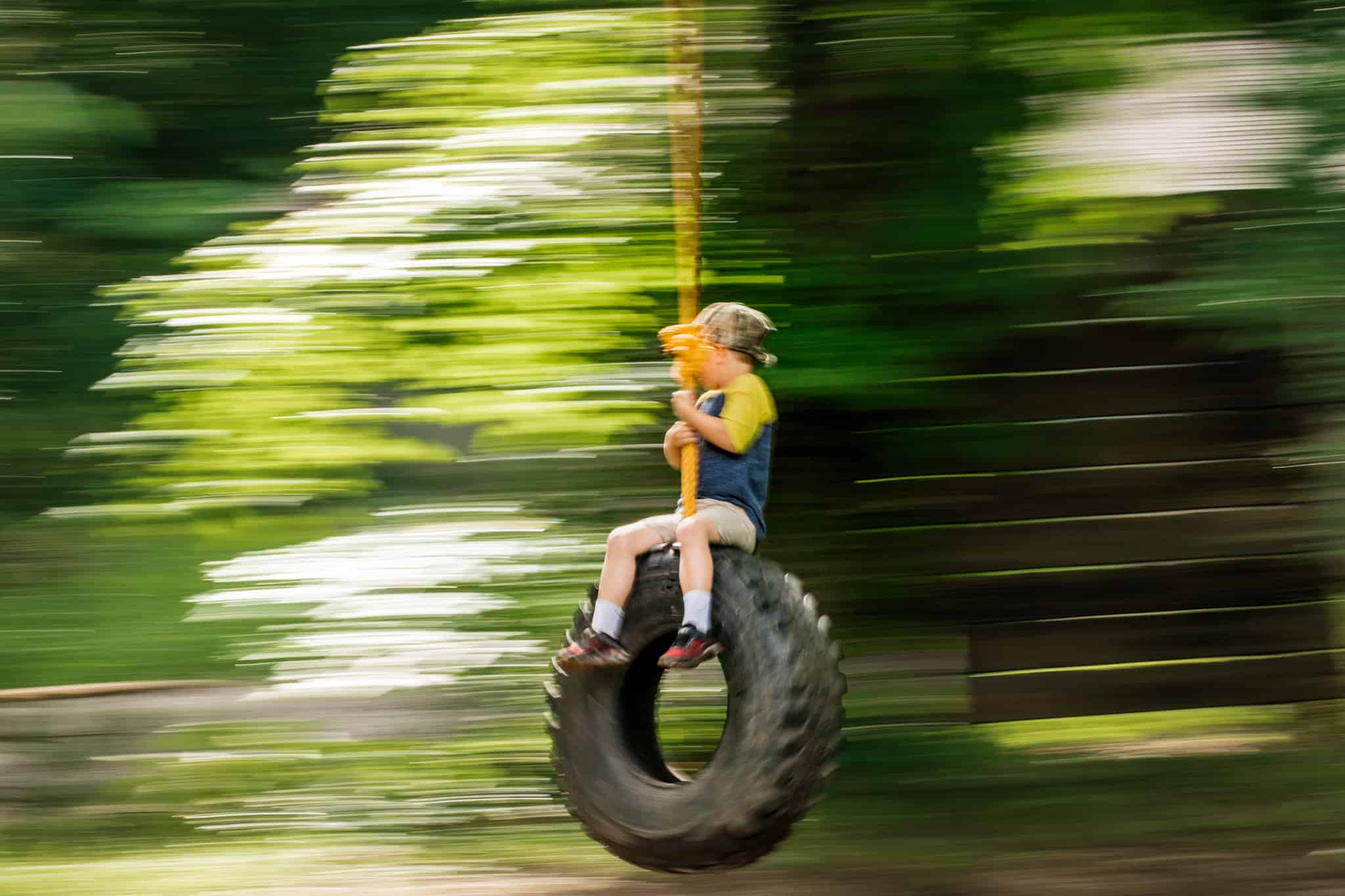 Boy on tire swing panning effect 