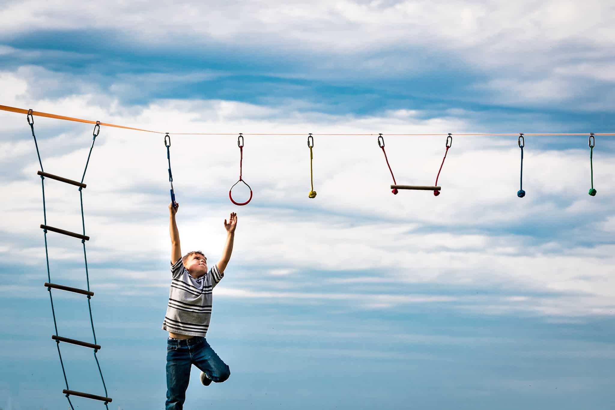 Child swinging from one handle to another 