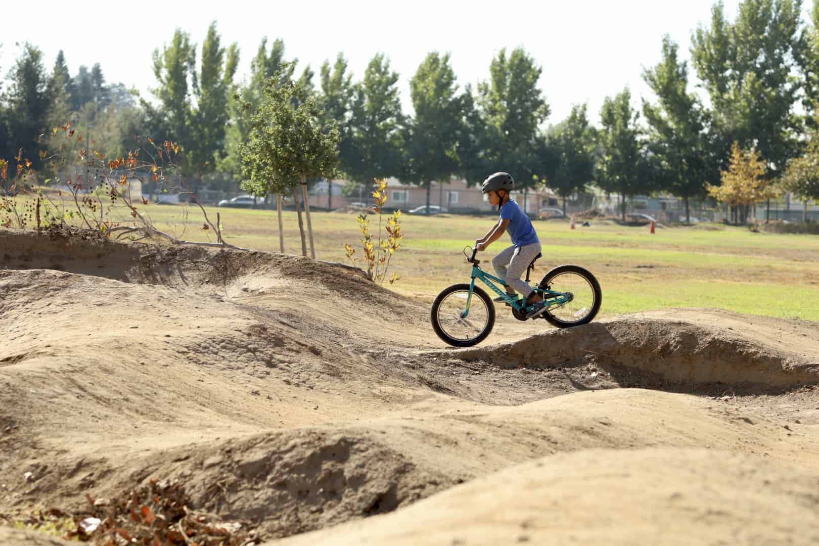 Kid bike riding at pump track