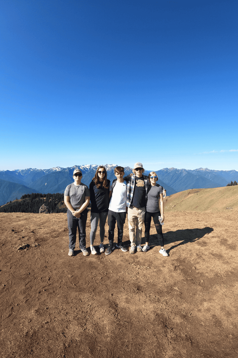 group of teens at the top of a summit on a hike in Olympic National Park