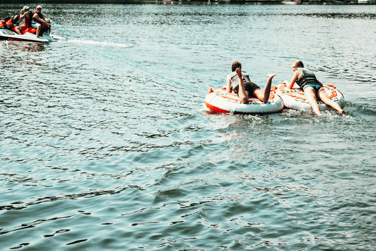 teens tubing in a lake