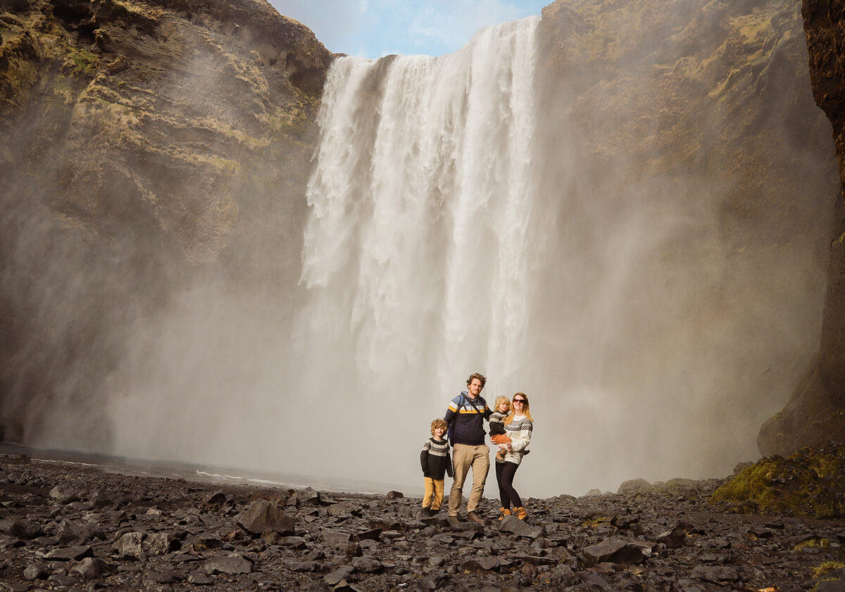 Family stood in front of waterfall in iceland