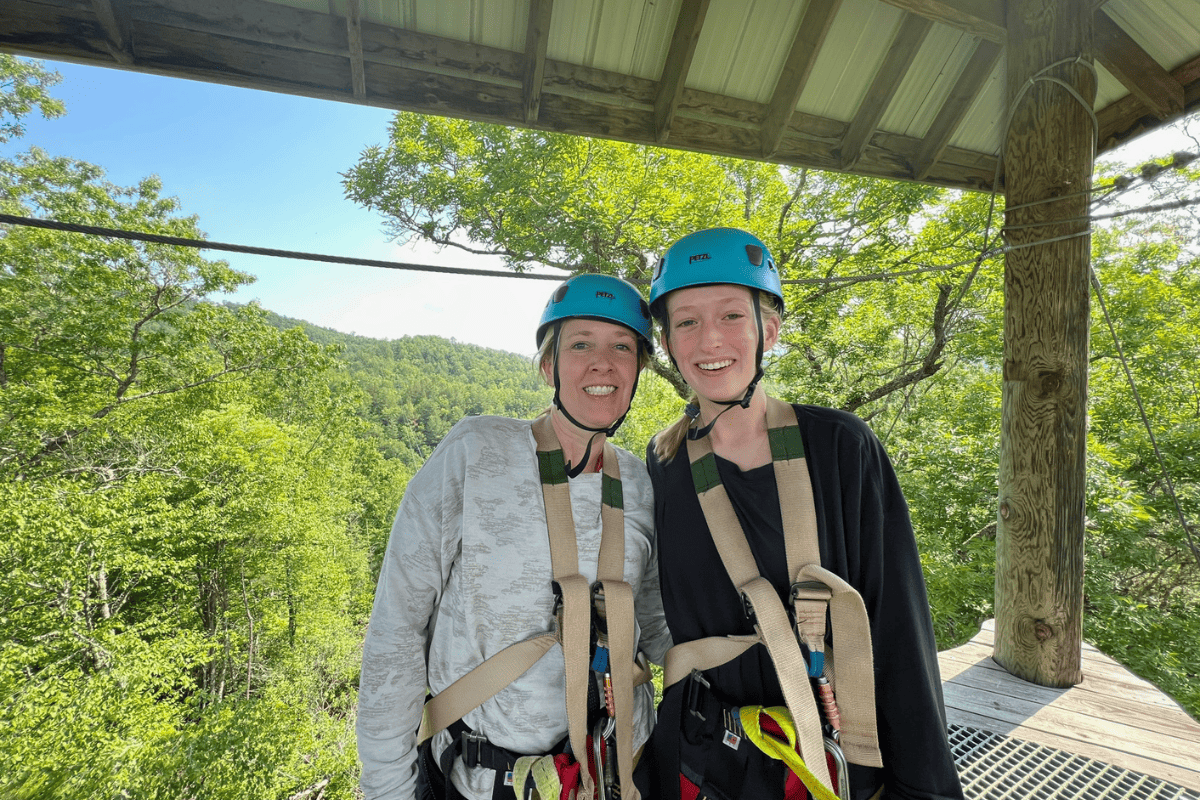 Mother Daughter ziplining on a platform in the trees near Bryson City, NC