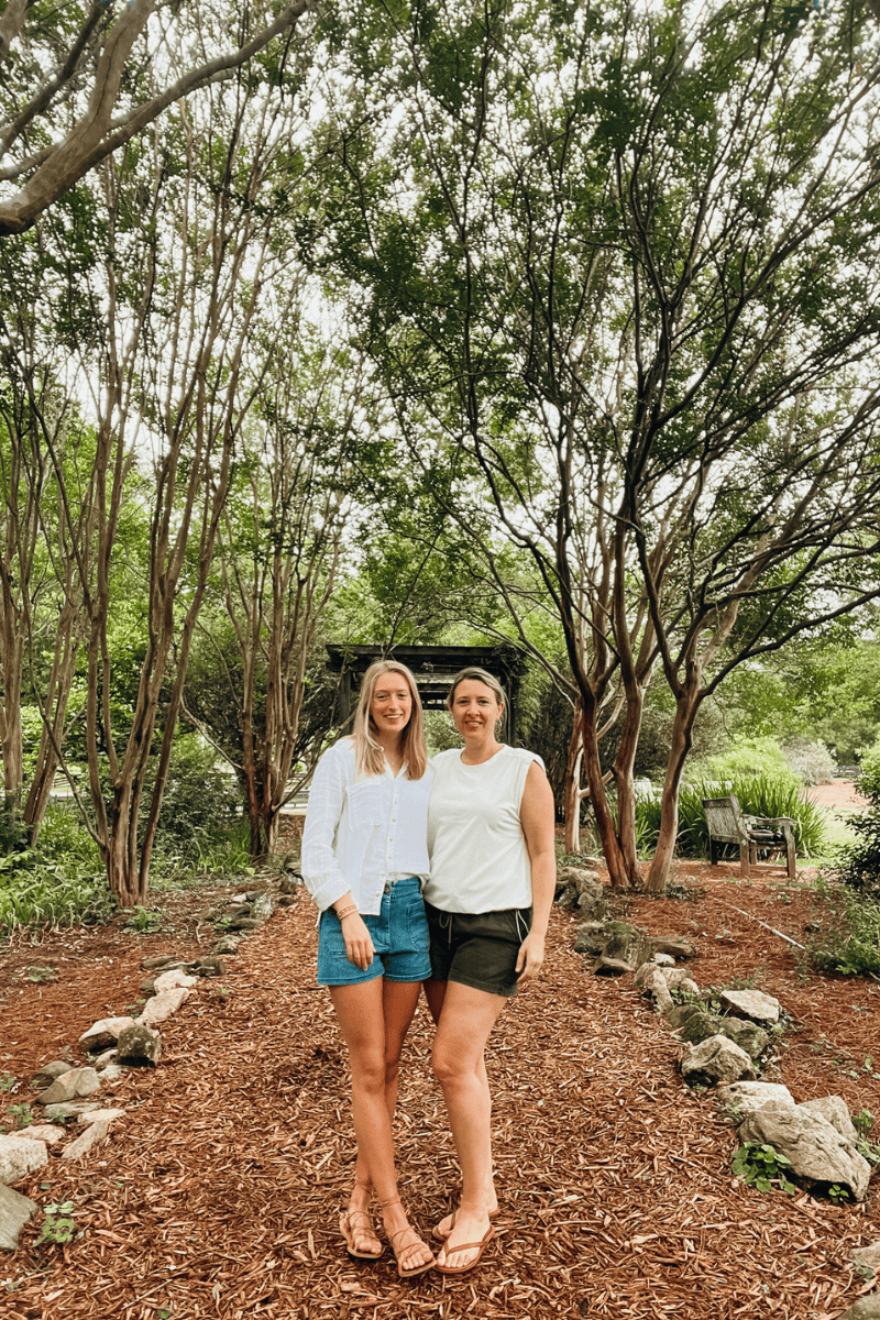 Mother Daughter photo on the grounds of the Inn at Serenbe surrounded by a canpoy of trees