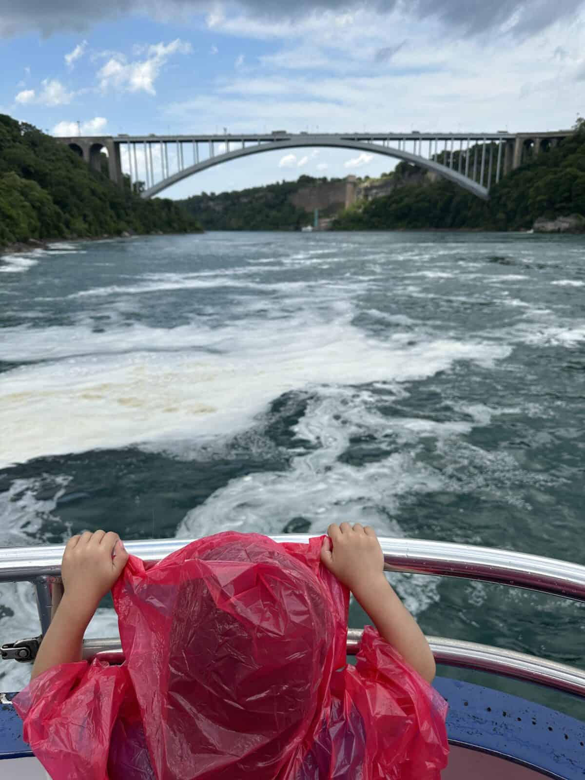 a kid looking at a bridge on a Niagara Falls Boat Tour