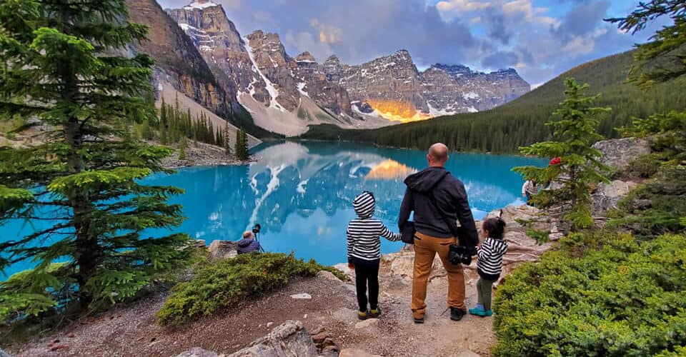 Parent and kids enjoy the view from the Rockpile at Moraine Lake in Banff National Park.