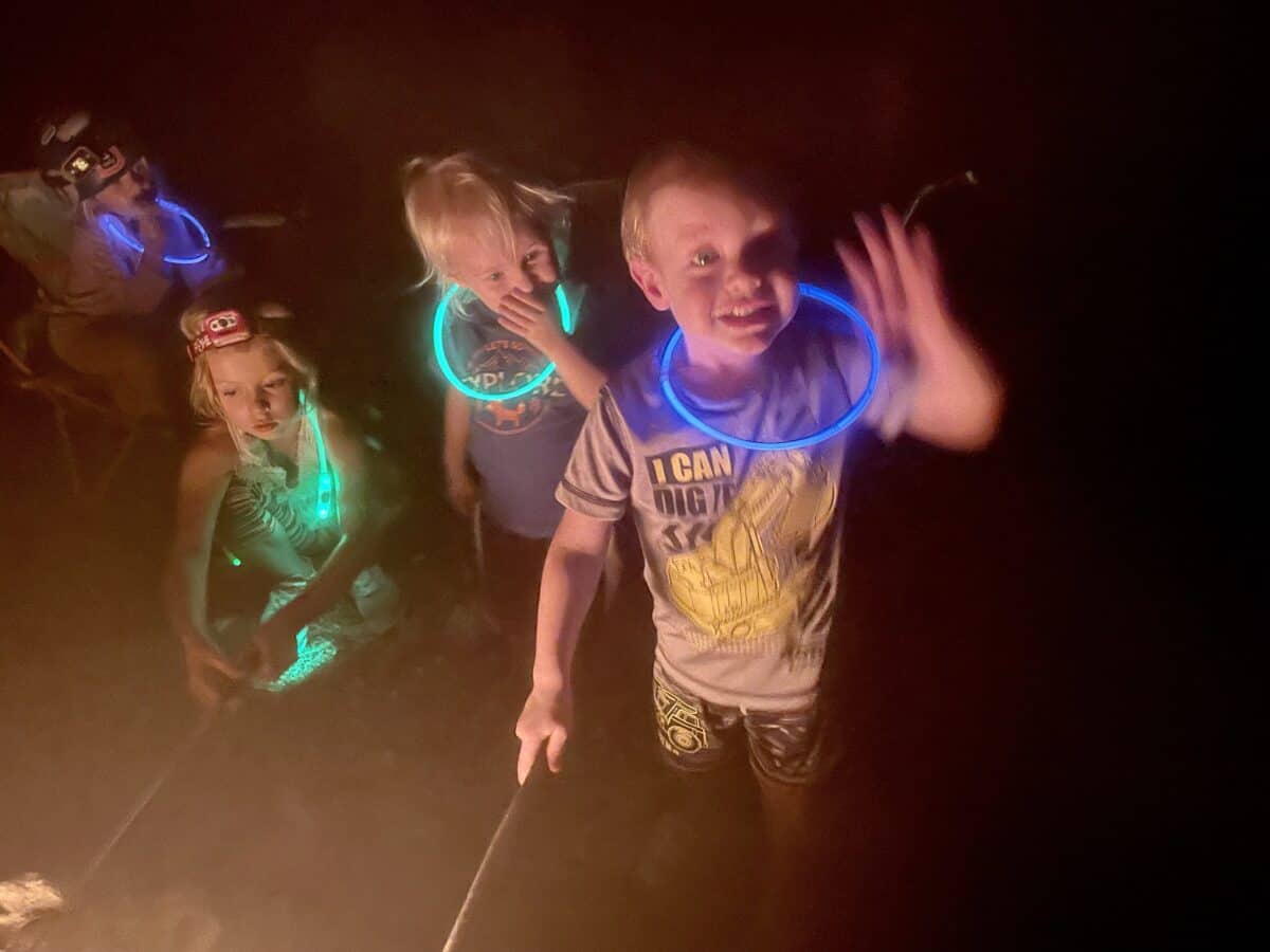 kids playing outside at night with glowsticks