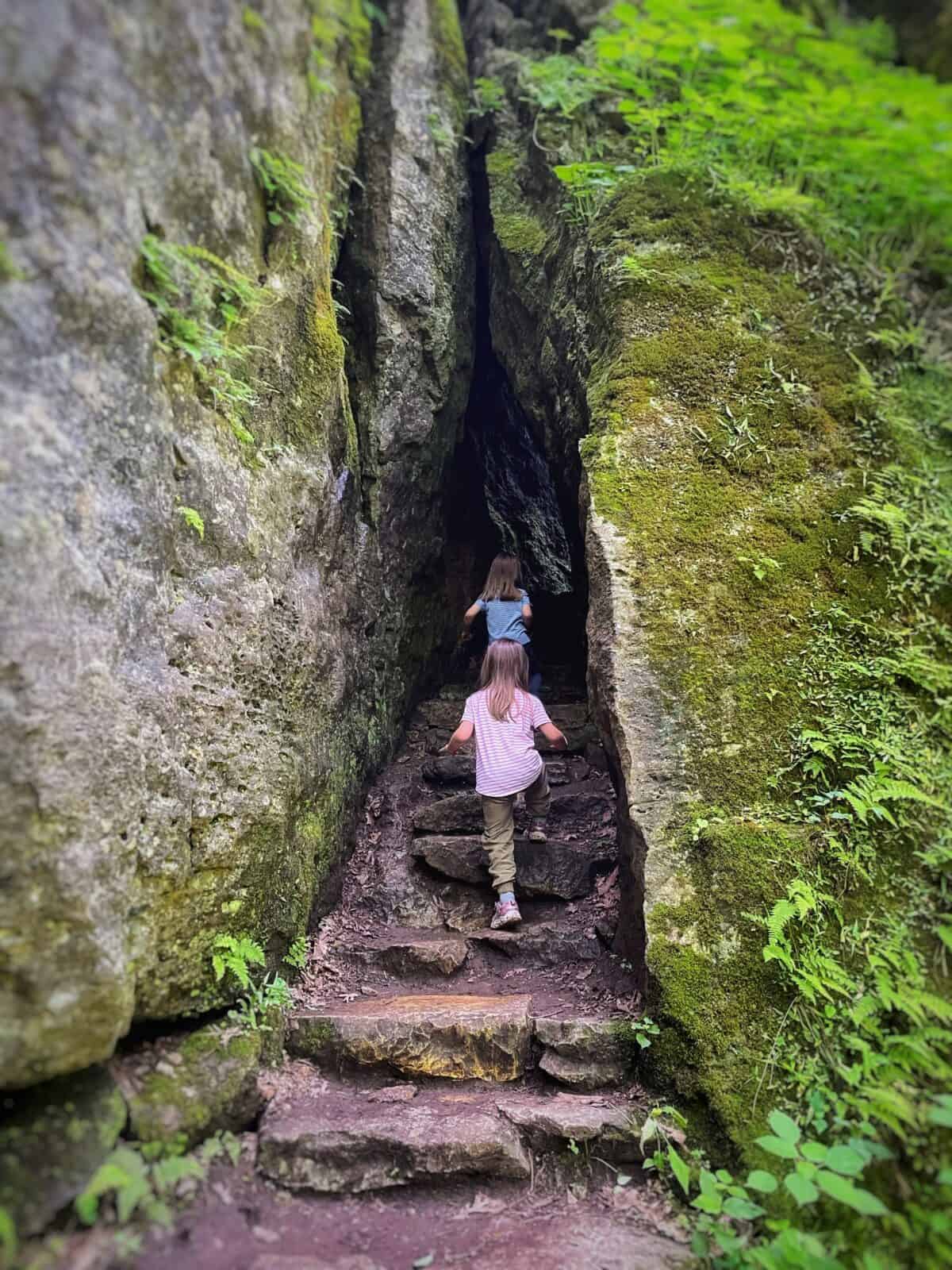 kids walking into a cave