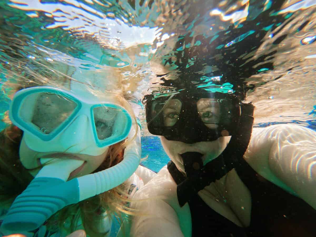 Mother daughter snorkeling underwater Belize