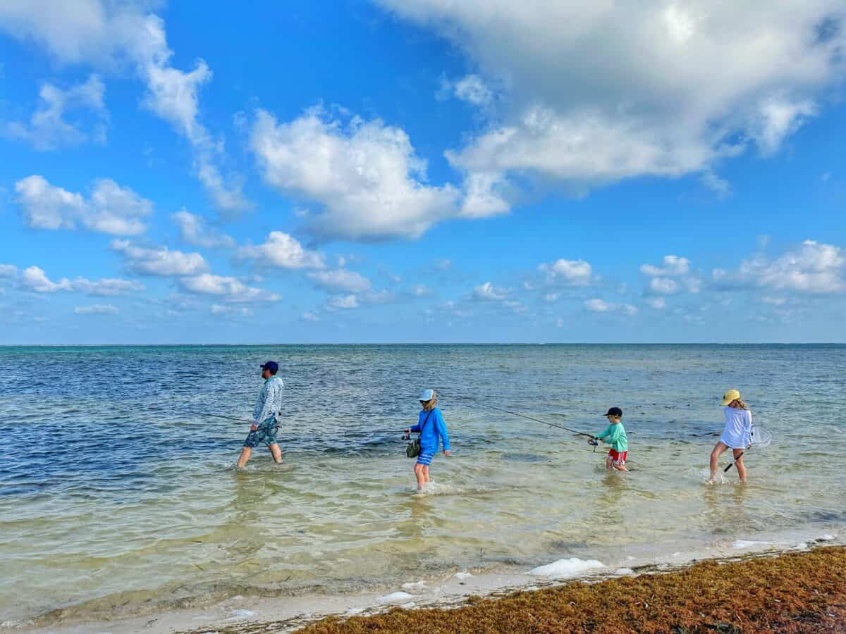 kids walking in the water next to the beach on ambergris caye