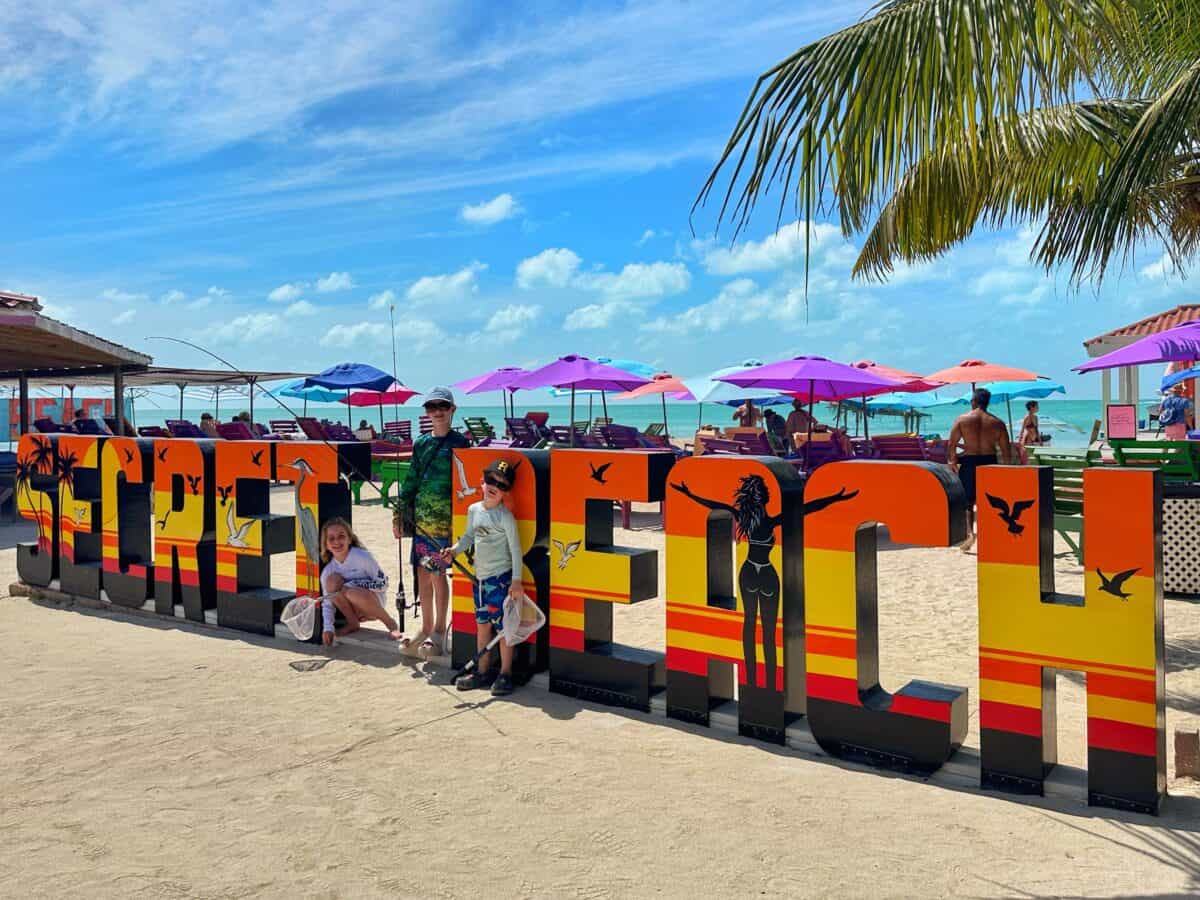 kids at Secret Beach sign Ambergris Caye Belize