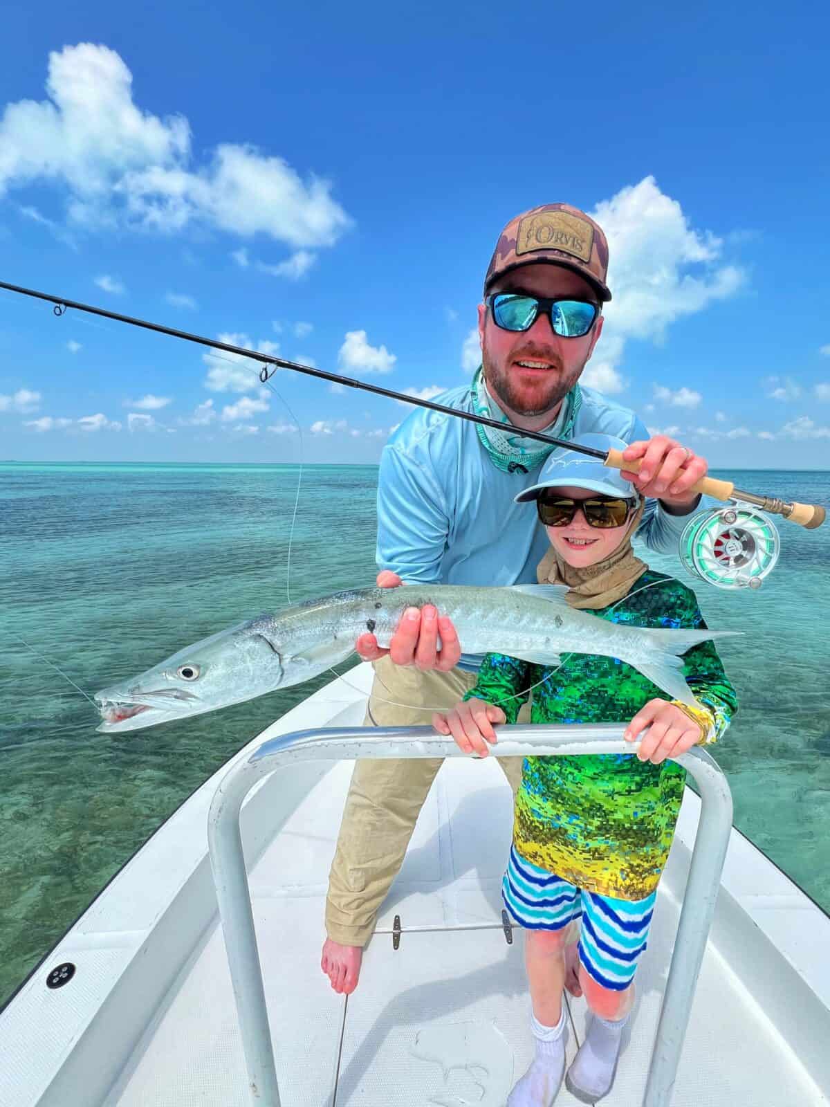 father and son holding barracuda - fishing belize